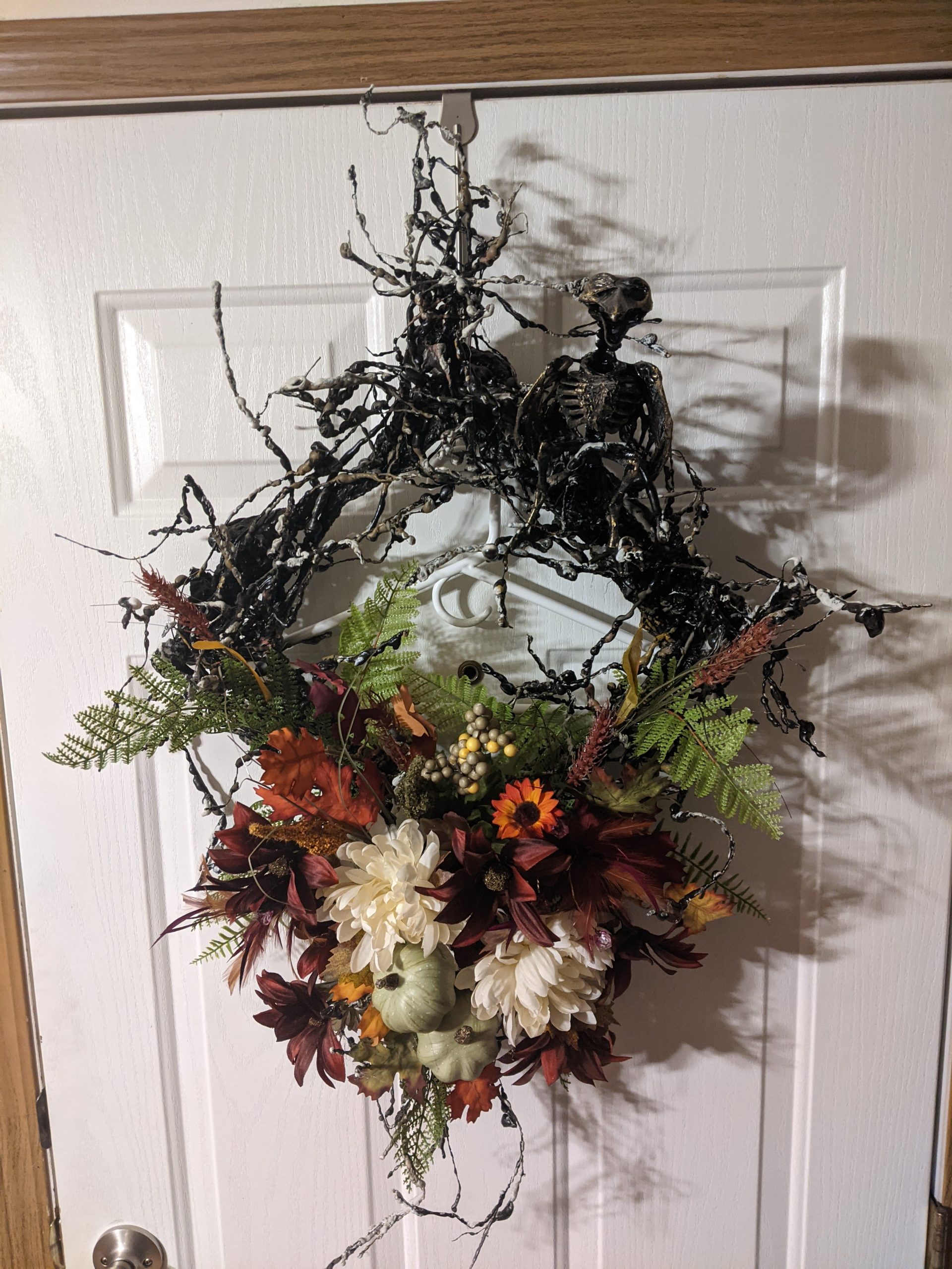 Fall diamond shaped wreath with raven skeleton.