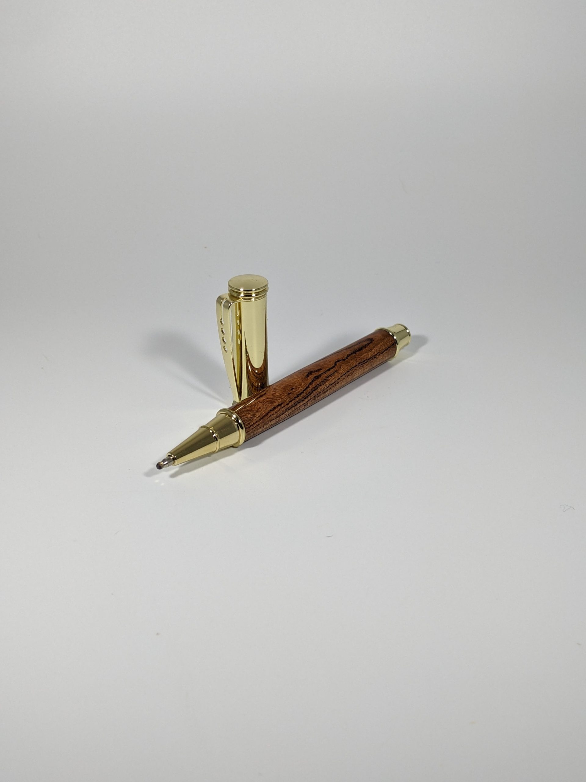 Gold Tiny giant ballpoint pen with black cherry body.
